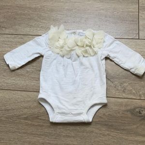 Koala baby 3 month girl white onesie with floral ruffle around neckline.